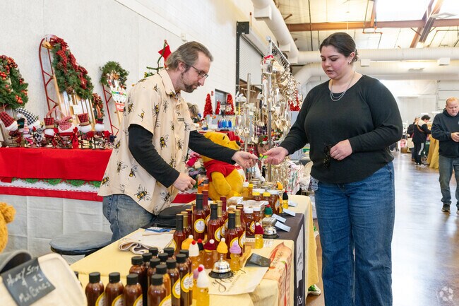 A vendor sells honey & sauces at the Christmas on the Fox Art & Craft Show in St. Charles.