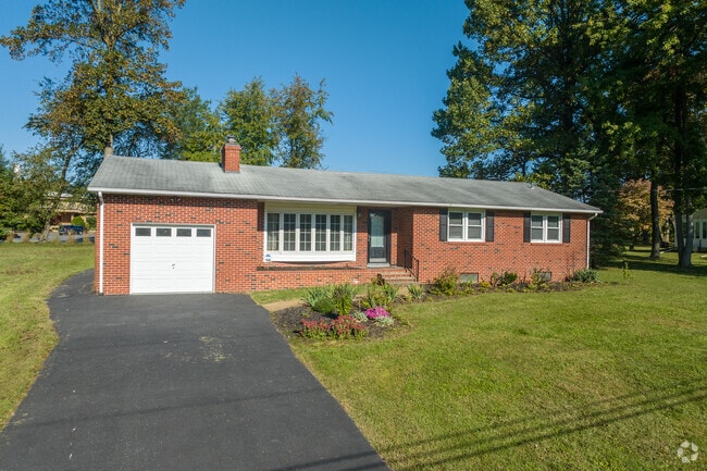 A classic, brick ranch home enjoys its spacious yard on a quiet Talleyville street.