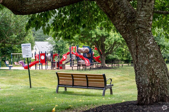 Relax on a bench under a tree to watch the sun set over Chester Heights Community Park.