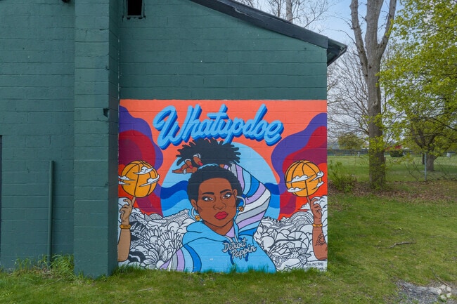 There is a Hipsterkuma and Ndubisi Okoye Whatupdoe mural at Butzel Playfield in Harmony Village.