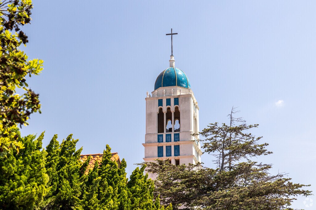 The Bell Tower and Cross seen from the Street Amongst Trees.