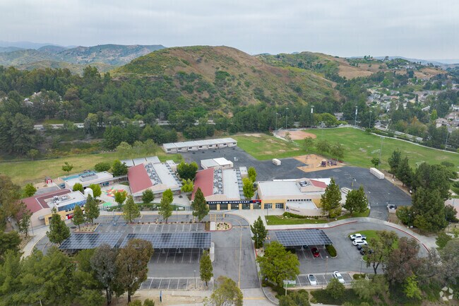 An elevated look at Canyon Rim Elementary surrounded by lush green trees and hills.