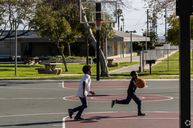 Children from Athens enjoying a game of basketball in Helen Keller Park