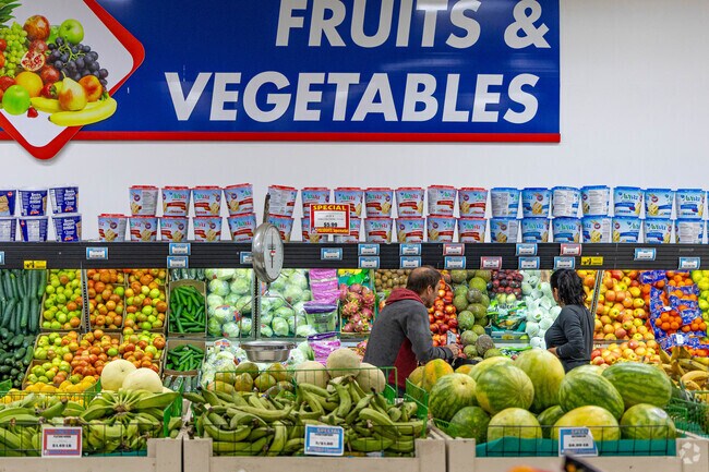Residents browsing produce in Cannongate neighborhood, savoring local flavors.