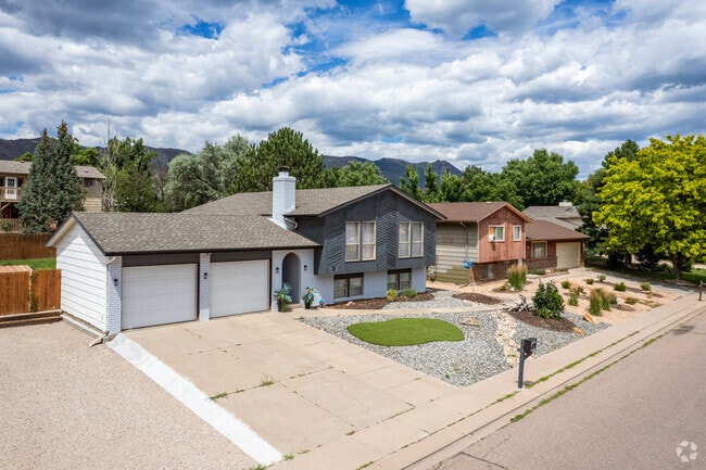 Traditional craftsman split-level homes line a street in Pine Cliff, Colorado.