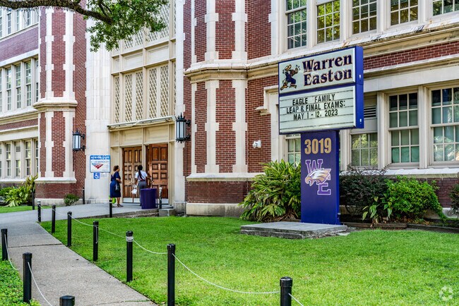 People walking in the front entrance of Warren Easton Highschool in the Iberville neighborhood.