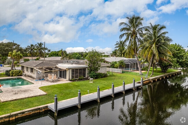 A row of ranch homes sits along the canal in the Snug Harbor neighborhood.
