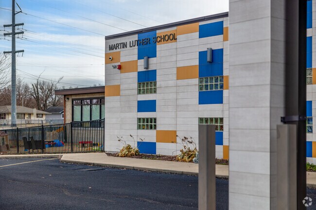 There is a sign for Martin Luther School near the front of the building.