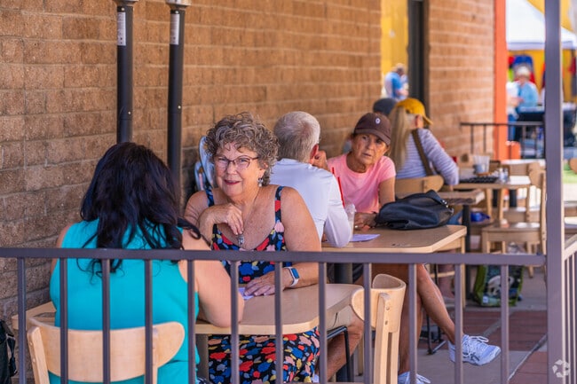 Locals relax and catch up outside Moqah Coffee and Beyond, a popular spot for breakfast and coffee in Green Valley.