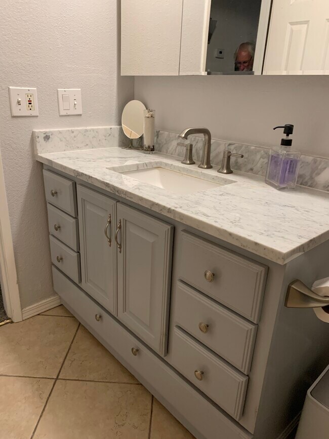 Updated bathroom vanity with new marble top and sink