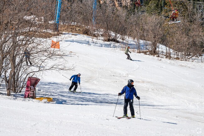Skiers and snowboarders enjoy a suny day at Sandia Peak Ski Area.