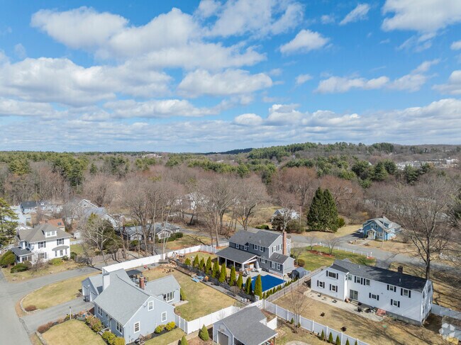 An aerial view of Upper Main Street reveal rows of well-kept homes, mature trees, and classic New England charm.