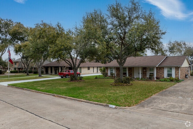 Older, Ranch-style homes in Deer Park Gardens rest underneath adolescent oak trees.