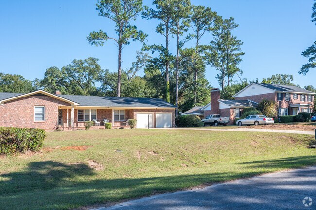A ranch and colonial home stand side by side in the Radium Springs neighborhood.