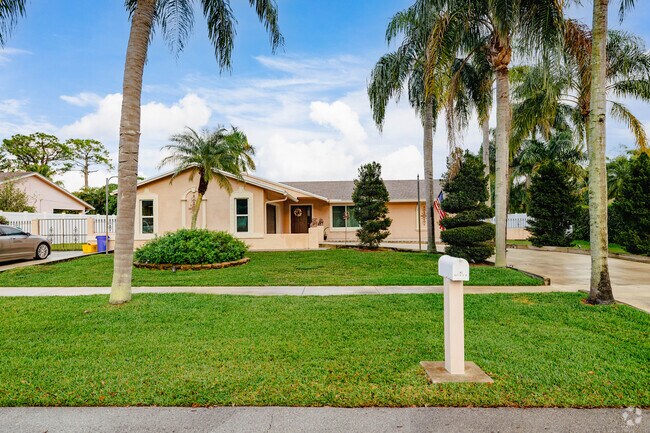 A meticulously landscaped ranch home with stunningly designed bushes.