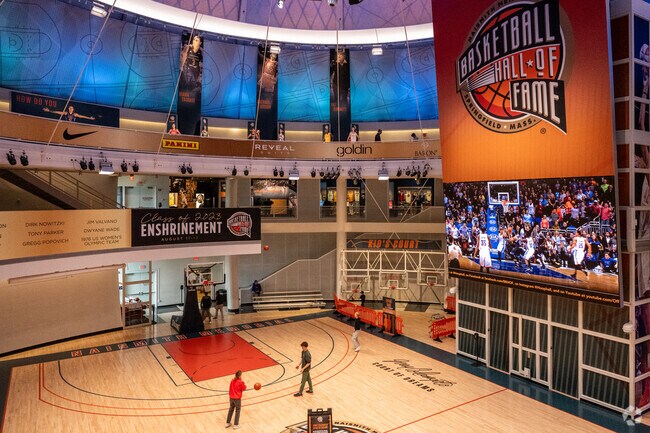 Some kids play on the court in the Naismith Memorial Basketball Hall of Fame in South End.
