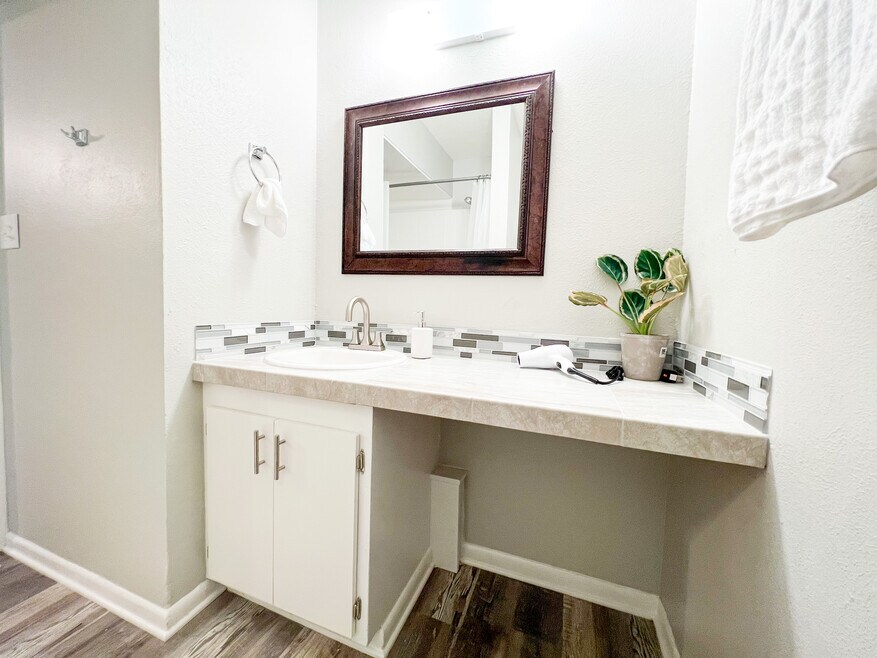 Luxury awaits in this renovated bathroom with tile finishes and new sink.