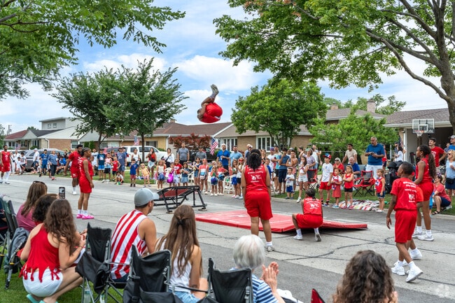 Courtland Park residents pack in to see the Jesse White Tumblers in the 4th of July parade.