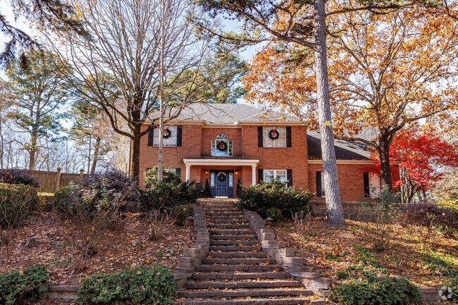 A colonial style home sits high atop a hill in Crystal Hill.