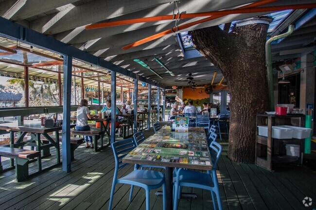 Diners are enjoying lunch on the porch at Whiteys Fish Camp.