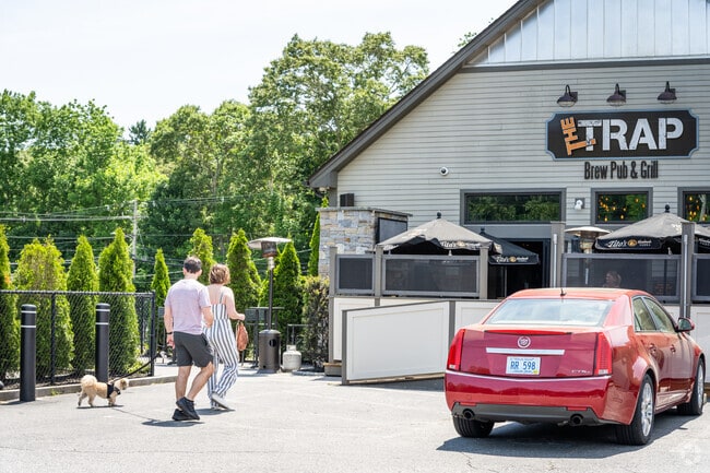 A couple, accompanied by their furry companions, is all set for a drink at The Trap, RI.