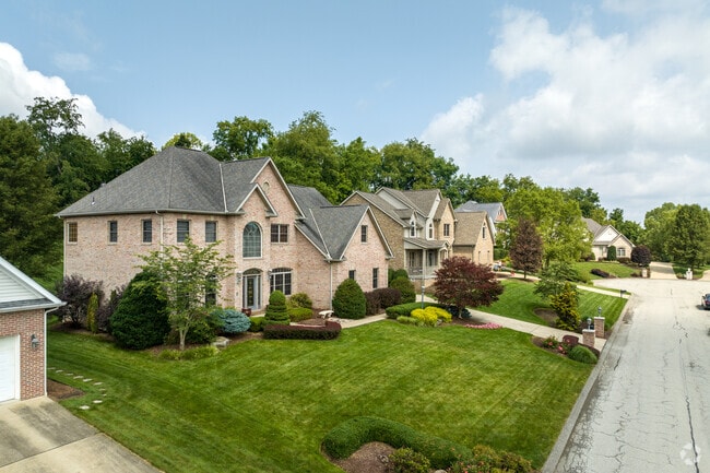 A row of large, brick homes lines this street in Plum.