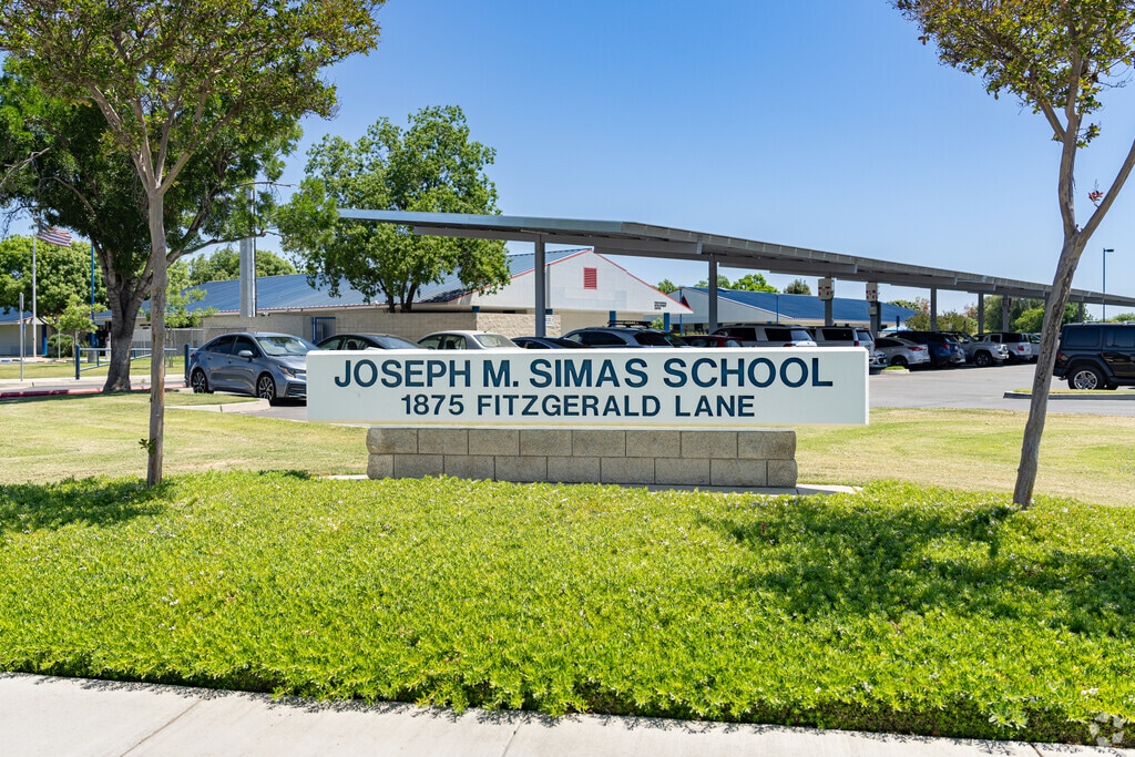 A large sign at the entrance to Joseph M. Simas Elementary School welcomes students.