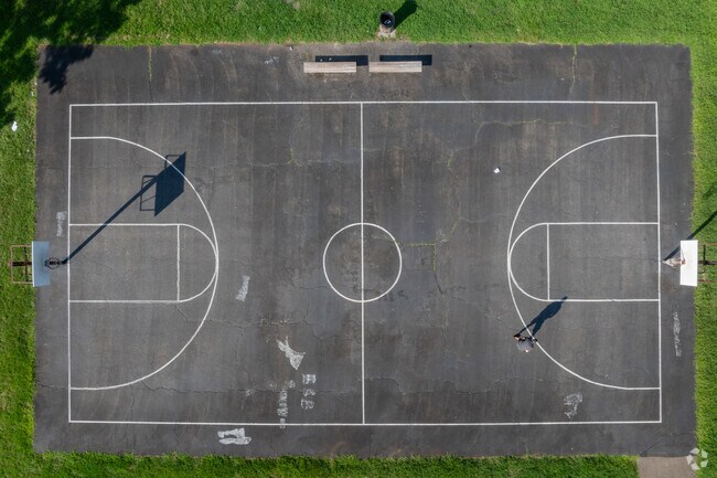 Play pickup basketball on the courts at Strauss Park.