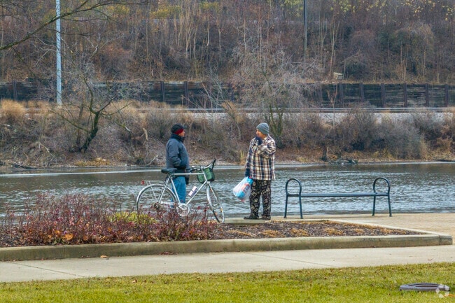 Stop and talk with a friend along the Riverside Drive Promenade near Southwest Elgin.