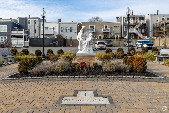 A powerful statue sits in front of Gate of Heaven Elementary School in Boston.
