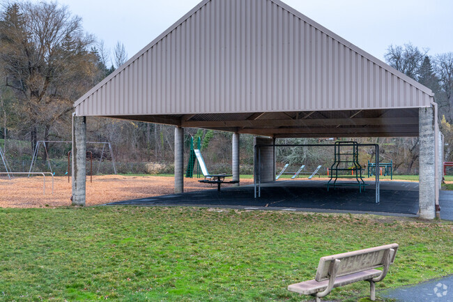 The playground features a covered basketball court.