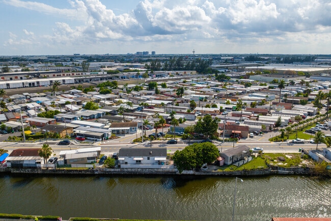 Single-family homes on the canal across from the Town of Medley mobile home park.