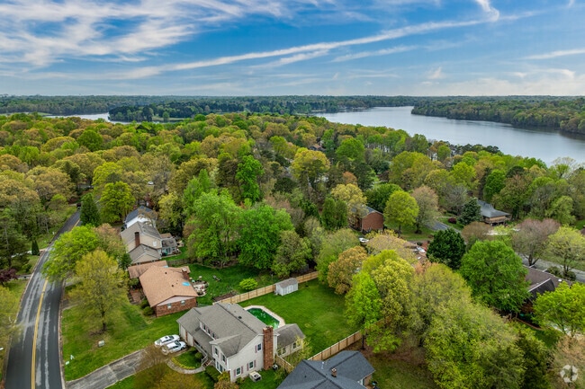 Deep River is a peaceful suburban neighborhood nestled in trees near Oak Hollow Lake.