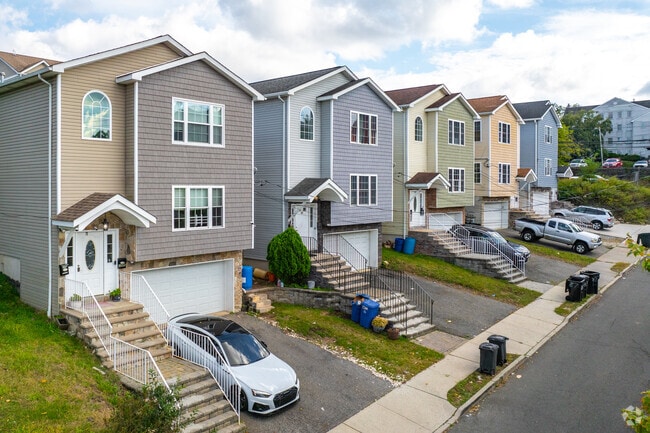 Colorful townhomes sit atop the hills of Old Great Falls, near Garret Mountain Reservation.