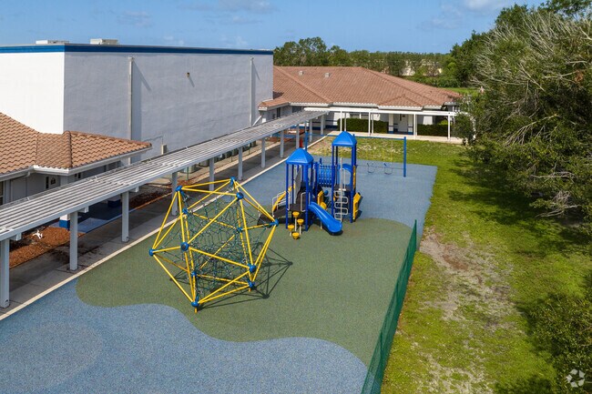 The younger children at De LasSalle Academy in Fort Myers have a protected playground to play on