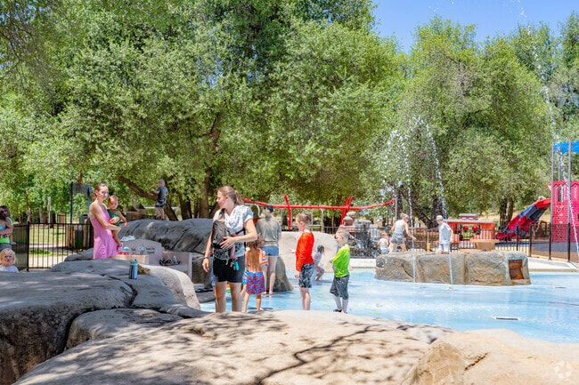Parents catch up with friend's as children play at Fantasy Fountain in Alta Mesa.