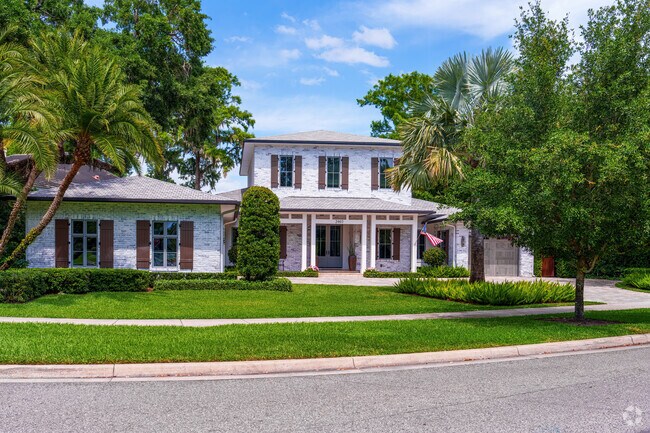 This stunning two-story Rose Isle home is a waterfront paradise with a brick exterior.