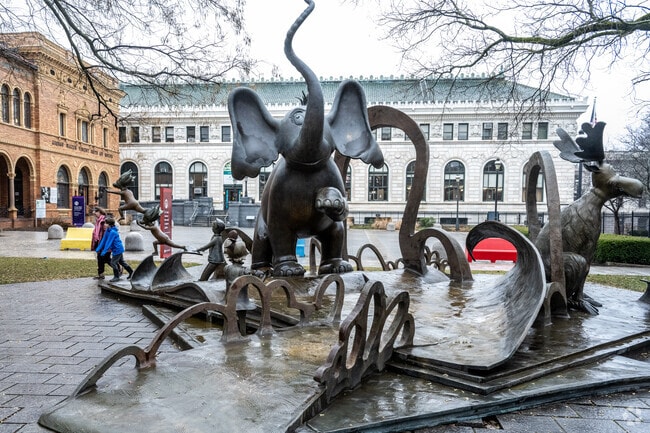 Kids pass the Dr. Seuss National Memorial Sculpture Garden in South End