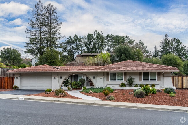Spanish Revival homes feature charming tile roofs, stucco exteriors, and arched doorways.