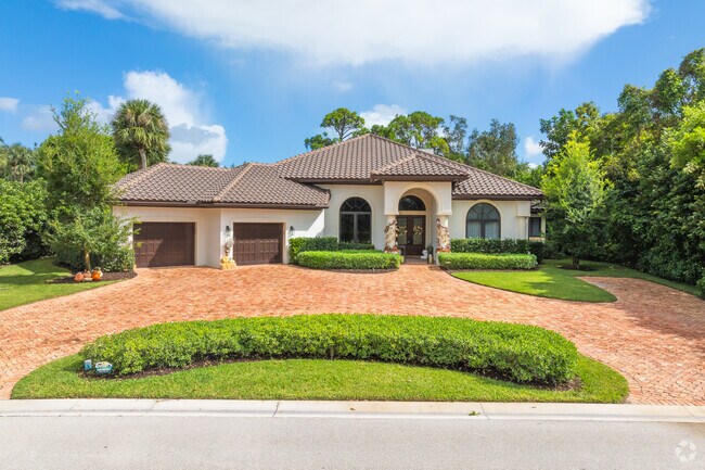 Baywinds home features Mediterranean design with stucco walls and terracotta clay style roofs.
