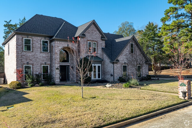 A brick New Traditional home sits on a wide lot in Reno, TX.