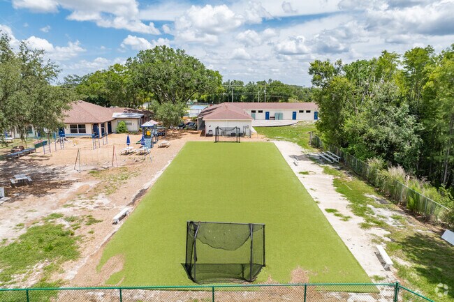 Students enjoy outdoor play on the sports courts at Genesis School .