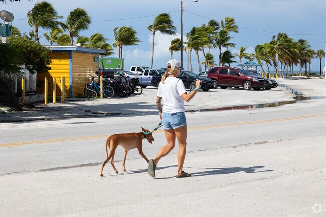 Resident of Casa Marina enjoys a walk with her furry friend.