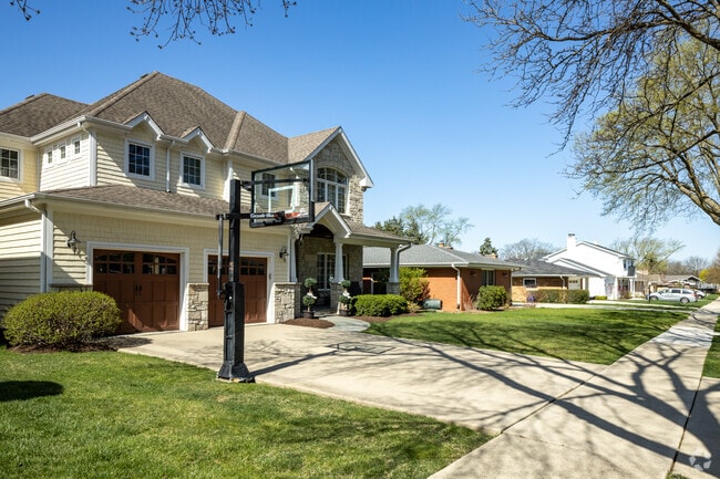 Modern Traditional Style Home With a Basketball Hoop in the Driveway Located in Springdale.
