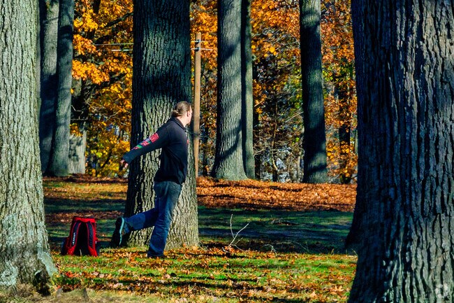 A man practices his drive at McGraft Park's disc golf course.