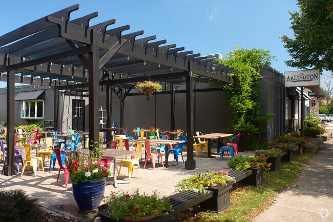 Colorful outdoor seating contrasts the stark exterior of The Arlington Gastropub in Hilton.