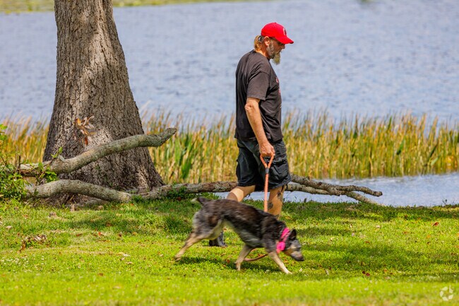 Lake Howell residents walk their pets along the walking loop around Red Bug Lake Park.