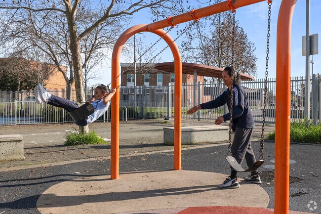 Joyful heights father and daughter at Nevin Park swings, Iron Triangle.