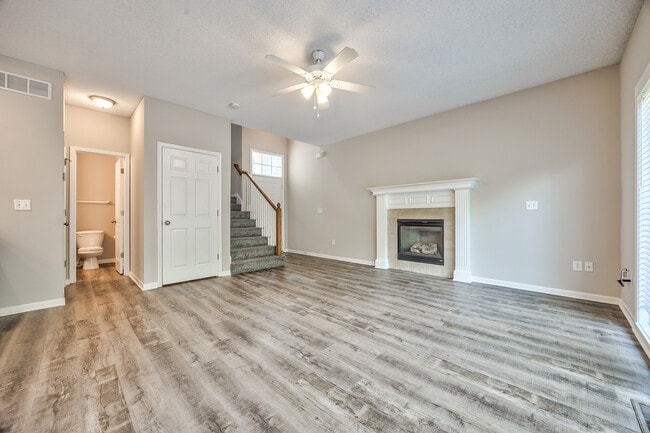 Living room with fireplace and ceiling fan