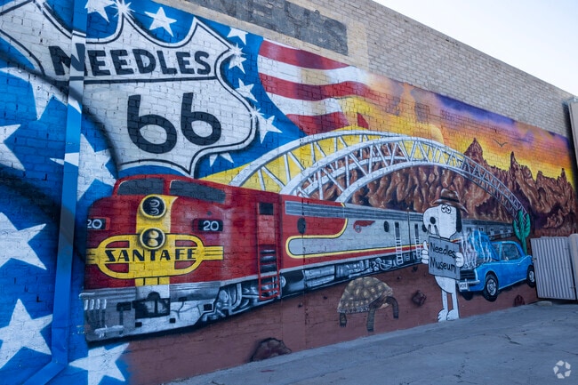 Adorning Needles Regional Museum, the vibrant mural unfurls tales of the town's past.